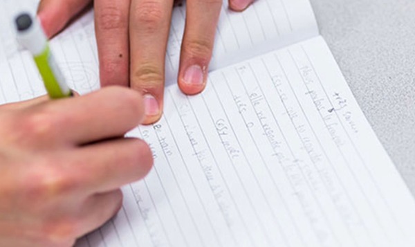 closeup of hands writing