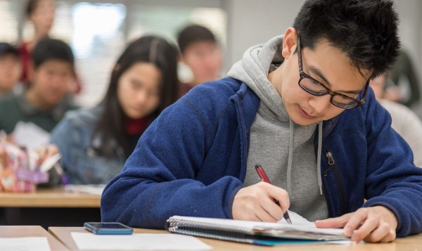 Student taking notes in class