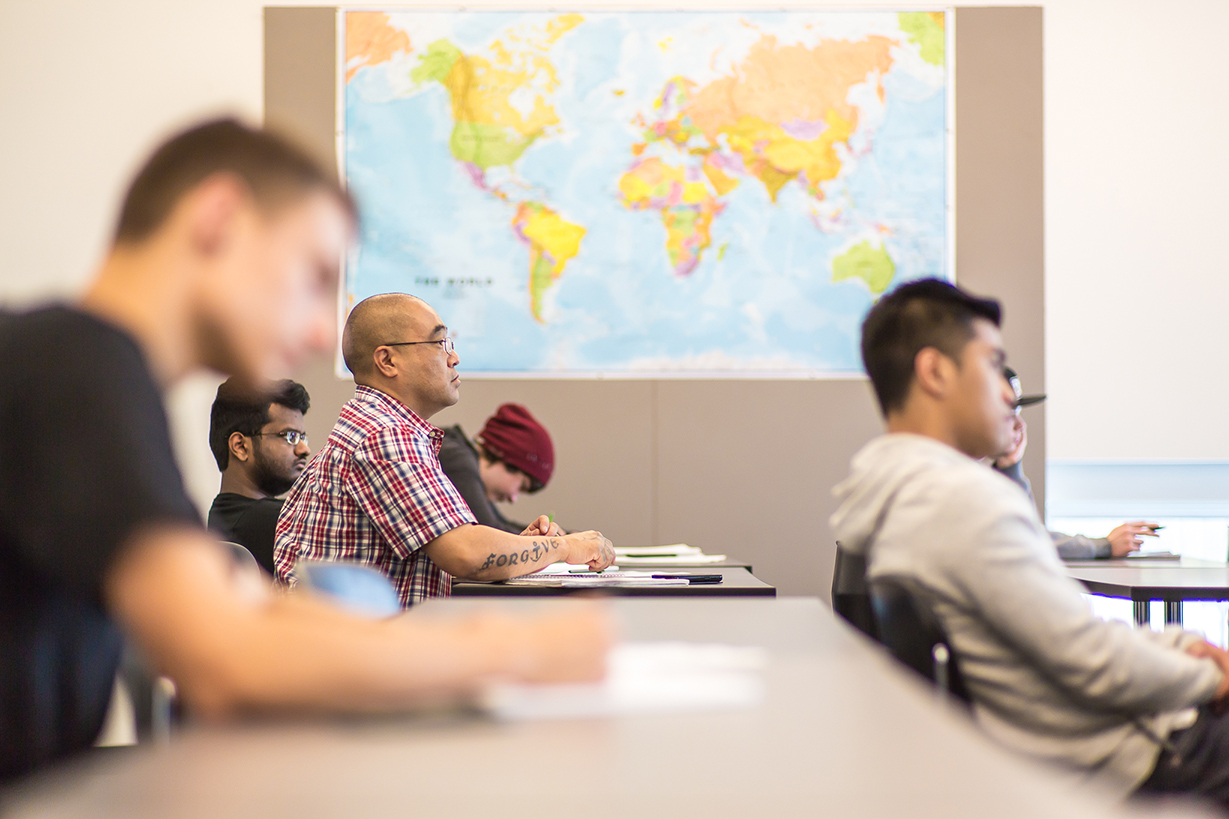 Students in classroom with map in background