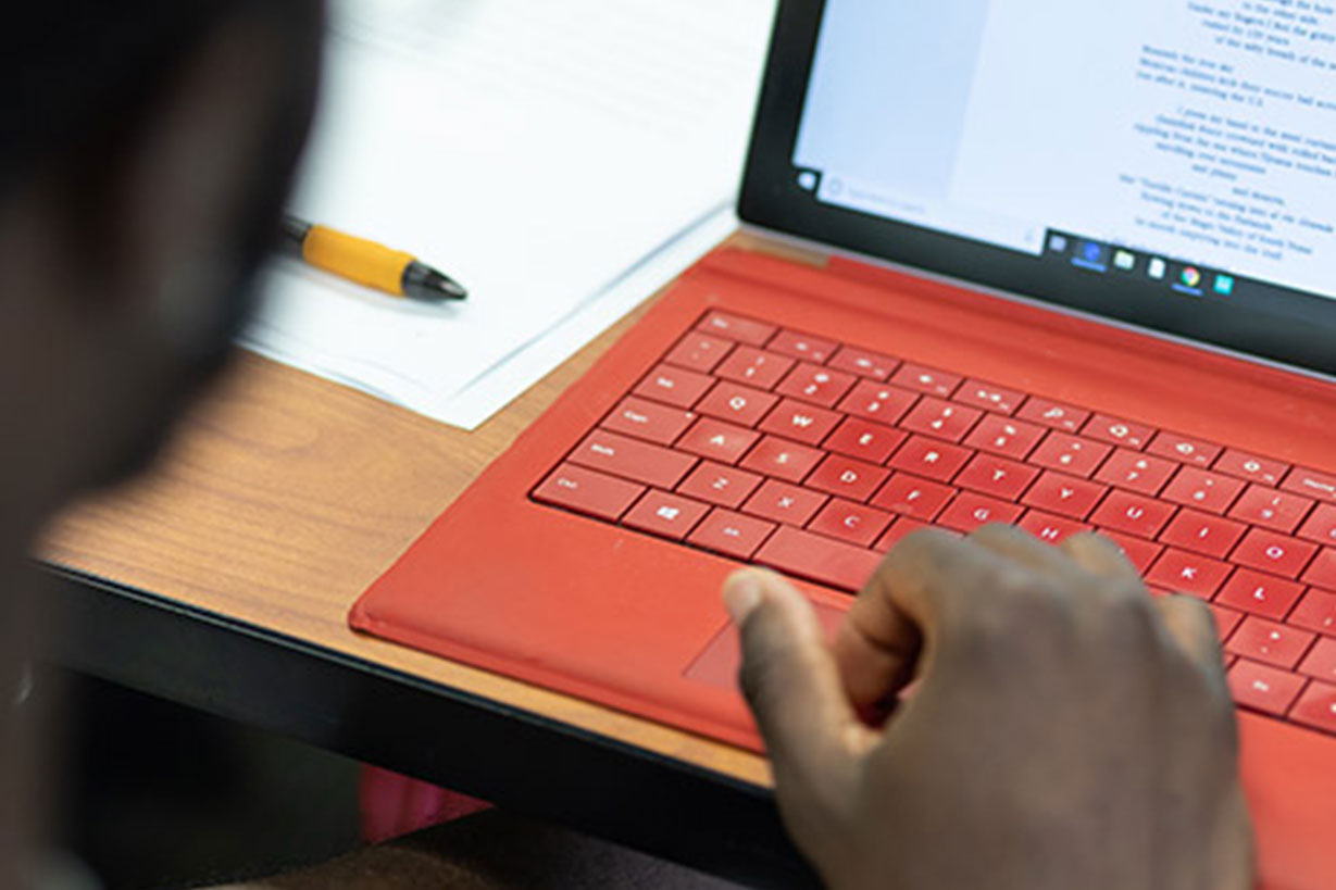 Student in front of red laptop