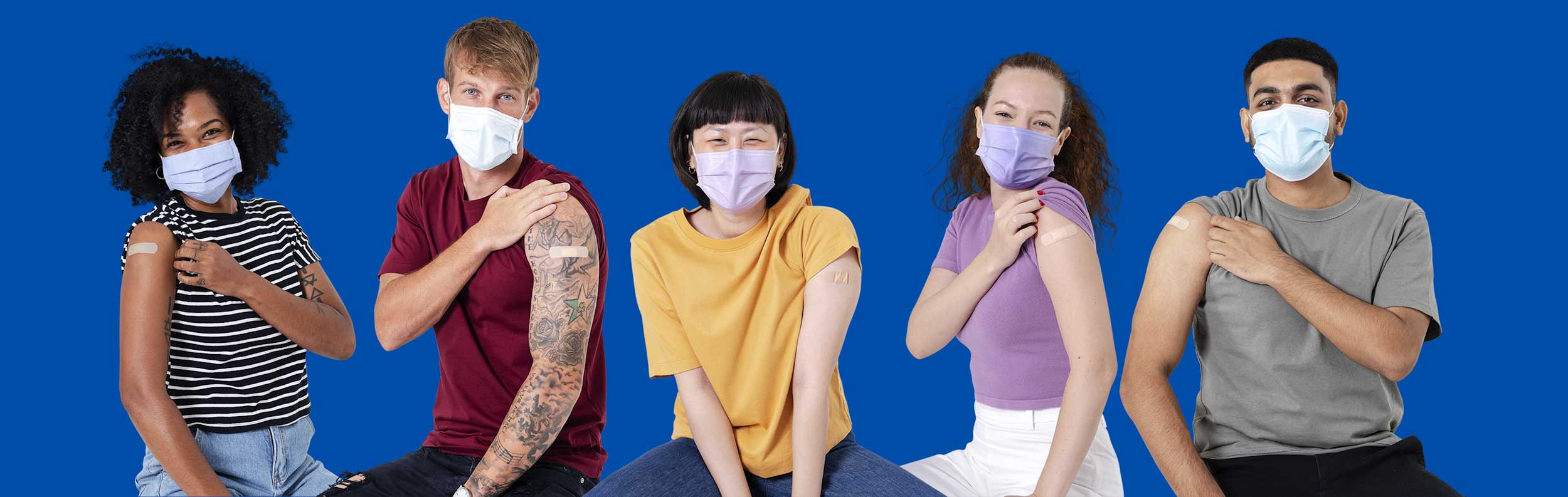  students wearing face masks and showing their arms with a bandage from vaccination (Image by rawpixel.com) 