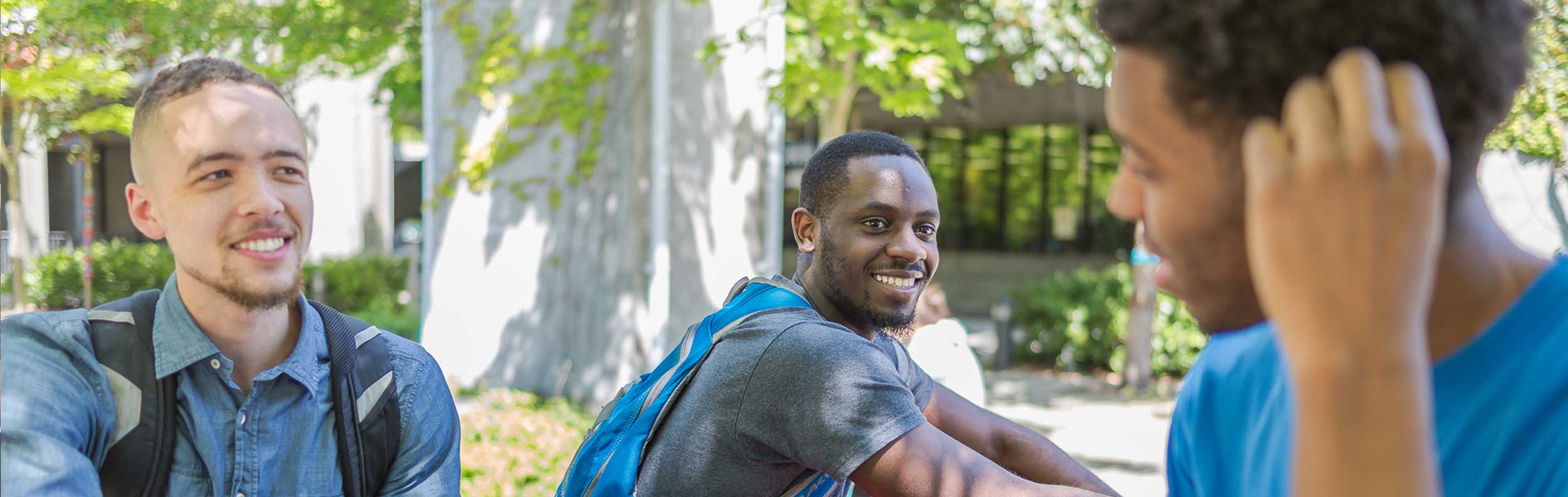  males outside smiling 